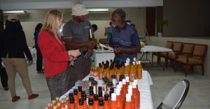 (L-R) Kathleen Pessolano and Kittitian Hill Representative speaking with Brimstone Flavors Representative