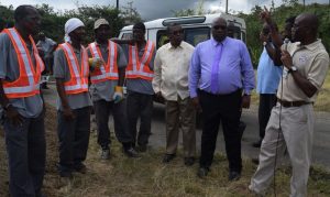 Dennison Paul, WSD Acting Manager (right), points as he outlines the Water Improvement Project to Prime Minister Harris (purple shirt) and Minister responsible for Water, Ian Patches Liburd (beige shirt), while WSD staff look on