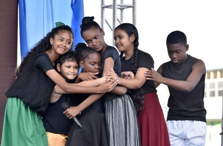 A group of children perform a skit at the Child Protection Week rally.